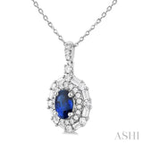 7x5 MM Oval Cut Sapphire and 5/8 Ctw Baguette & Round Cut Diamond Halo Precious Pendant With Chain in 14K White Gold