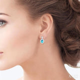 7X5 MM Oval Cut Blue Topaz and 1/20 Ctw Round Cut Diamond Semi-Precious Earring in Sterling Silver